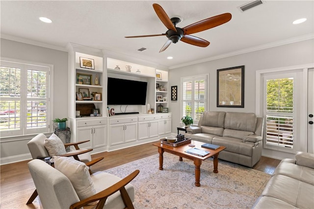 149 Harbor Pointe Dr, Brunswick, GA 31523 - living room featuring ceiling fan, plenty of natural light, wood finished floors, ornamental molding, and recessed lighting