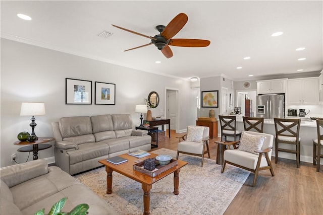 149 Harbor Pointe Dr, Brunswick, GA 31523 - living room with a ceiling fan, recessed lighting, light wood-style floors, baseboards, and ornamental molding