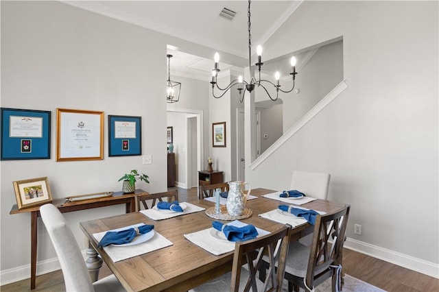 149 Harbor Pointe Dr, Brunswick, GA 31523 - dining room featuring wood finished floors, high vaulted ceiling, baseboards, a chandelier, and crown molding