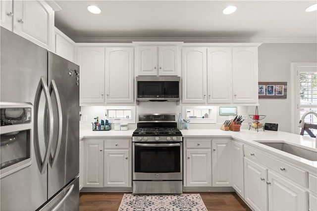 149 Harbor Pointe Dr, Brunswick, GA 31523 - kitchen with stainless steel appliances, a sink, dark wood finished floors, white cabinetry, and recessed lighting