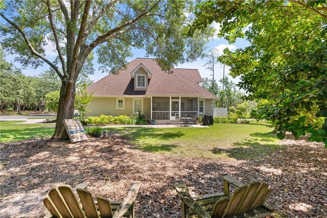 149 Harbor Pointe Dr, Brunswick, GA 31523 - view of front of property with a sunroom and a front yard