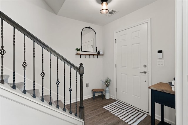 entryway with dark hardwood / wood-style flooring