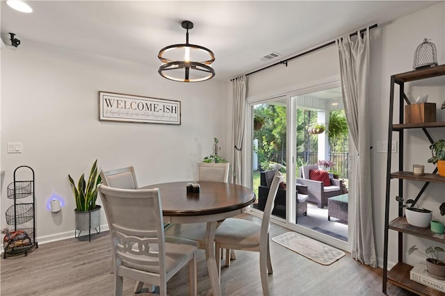 dining room featuring hardwood / wood-style floors and a chandelier