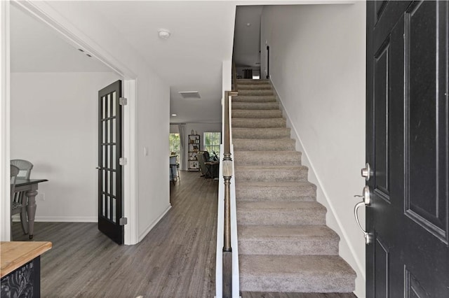 foyer entrance featuring dark wood-type flooring