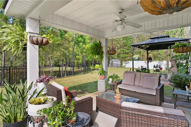 view of patio featuring a gazebo, ceiling fan, and an outdoor living space