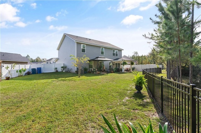 back of property with a gazebo and a lawn