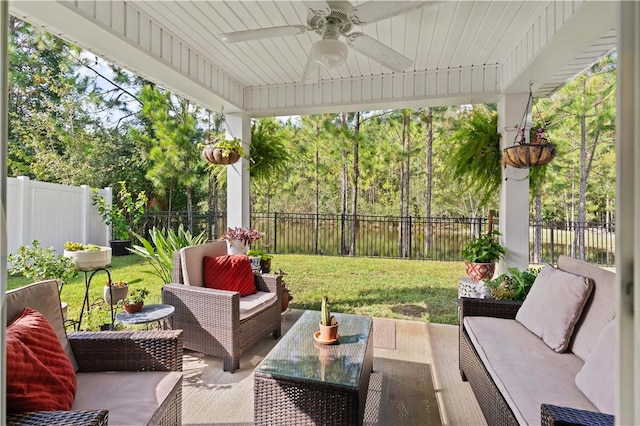 sunroom featuring ceiling fan