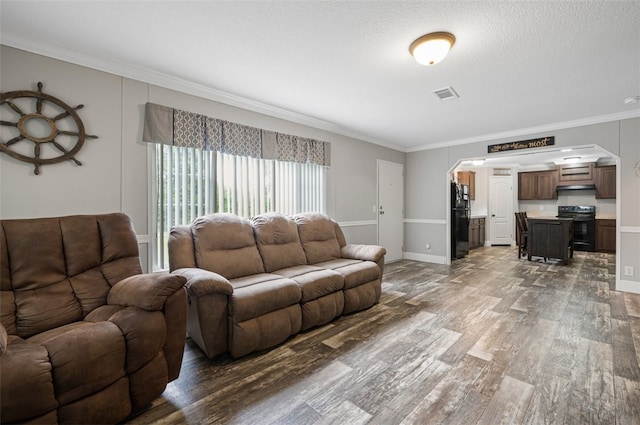 living room featuring ornamental molding, a textured ceiling, and dark wood-type flooring