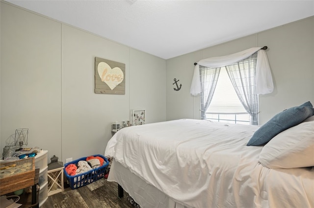 bedroom with dark hardwood / wood-style flooring