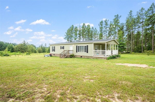 manufactured / mobile home with covered porch and a front yard