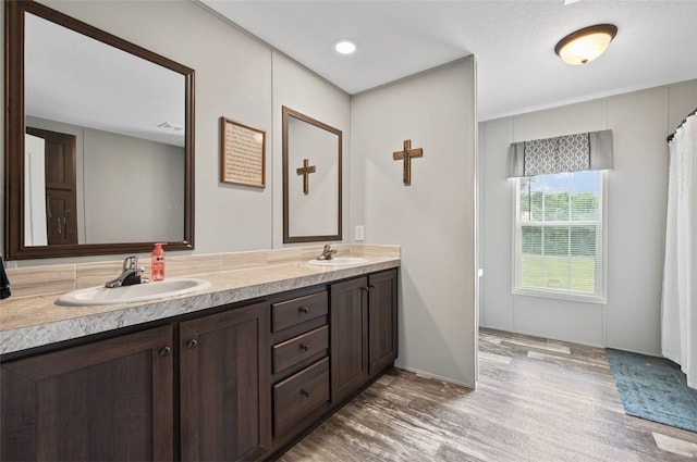 bathroom featuring hardwood / wood-style floors, vanity, and a textured ceiling