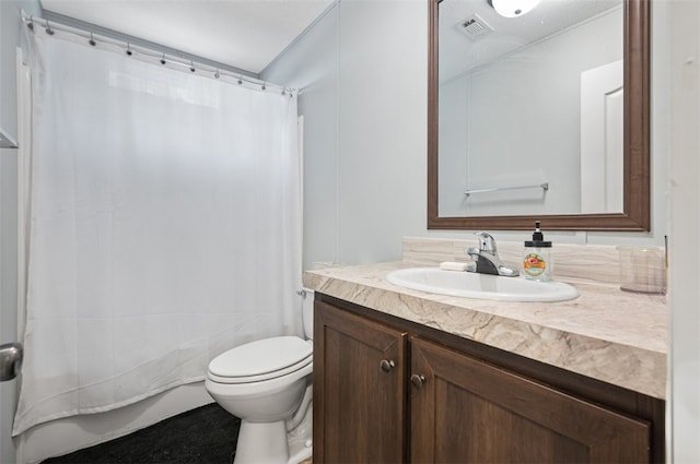 bathroom featuring vanity, toilet, and walk in shower