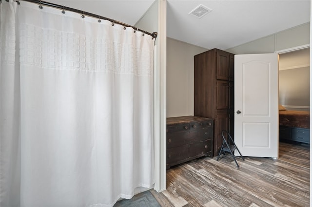 bathroom with hardwood / wood-style flooring