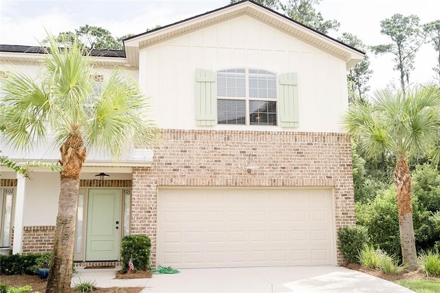 801 Mariners Cir, Saint Simons Island, GA 31522 - view of front of house featuring brick siding, driveway, a garage, and board and batten siding