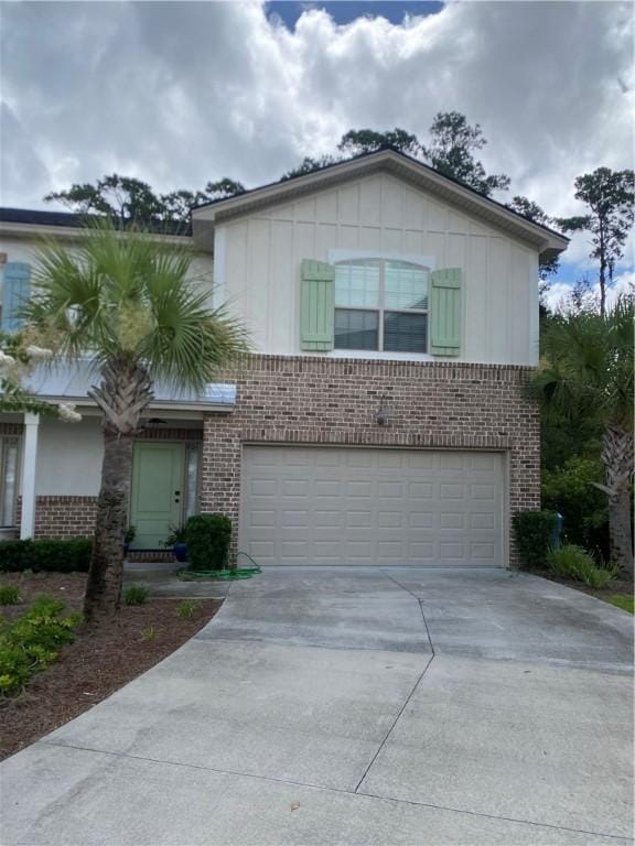801 Mariners Cir, Saint Simons Island, GA 31522 - view of front of house with brick siding, a garage, and driveway