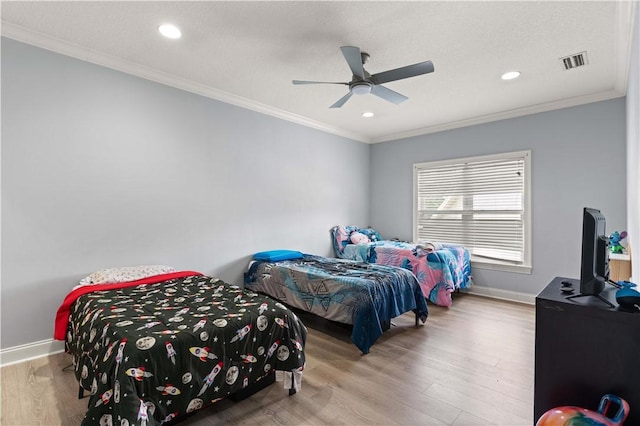 bedroom with ceiling fan, crown molding, and light hardwood / wood-style flooring