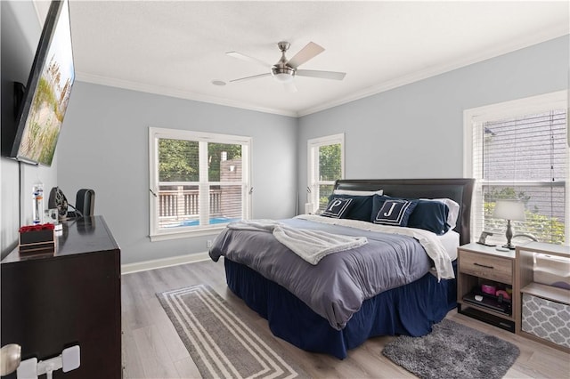 bedroom featuring ceiling fan, crown molding, and hardwood / wood-style flooring