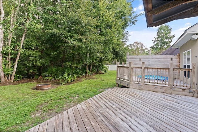 deck featuring a fire pit and a lawn