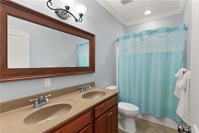 bathroom featuring tile patterned floors, crown molding, vanity, and toilet