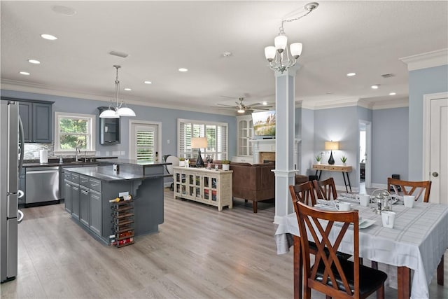 kitchen featuring light hardwood / wood-style floors, a kitchen island, a healthy amount of sunlight, and appliances with stainless steel finishes