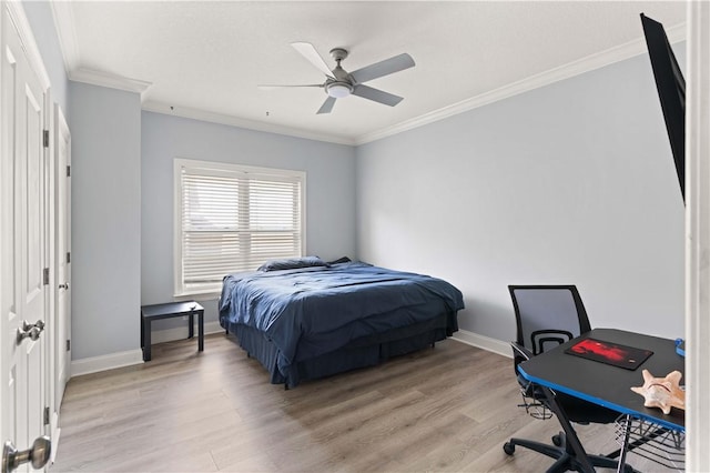 bedroom featuring ceiling fan, light wood-type flooring, and ornamental molding