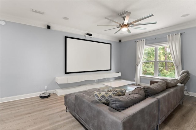 cinema featuring ceiling fan, light hardwood / wood-style floors, and crown molding