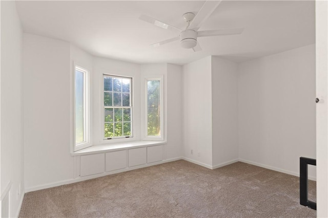 carpeted empty room with ceiling fan