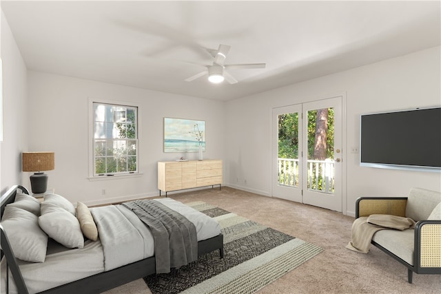 bedroom with access to outside, ceiling fan, and light colored carpet