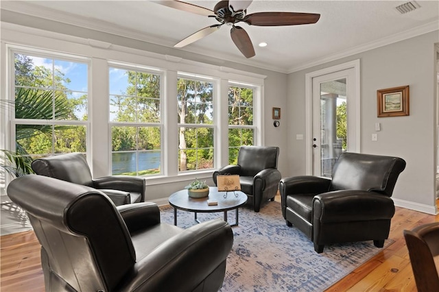 sunroom / solarium with plenty of natural light and ceiling fan