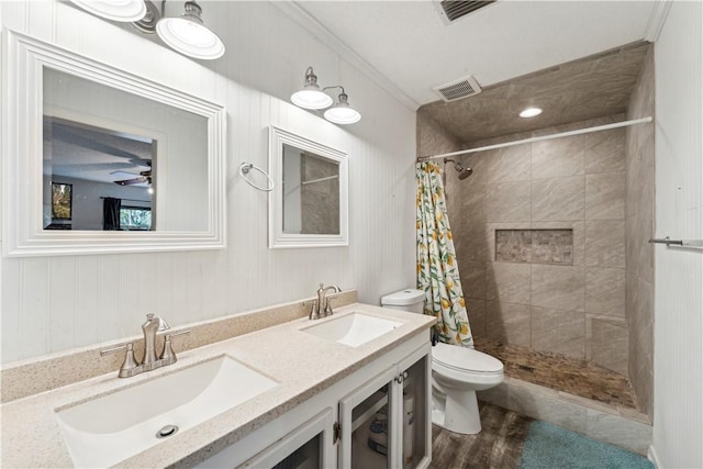 bathroom featuring ornamental molding, a shower with curtain, vanity, wood-type flooring, and toilet