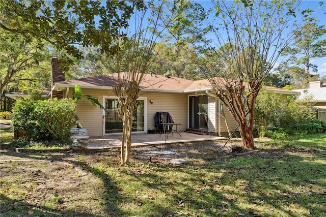 146 Sherwood Forest Cir, Brunswick, GA 31525 - rear view of house with a chimney and a patio area