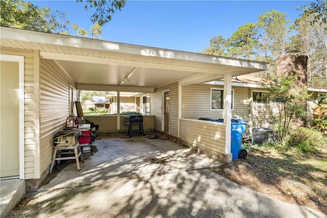 view of patio / terrace featuring a carport and cooling unit