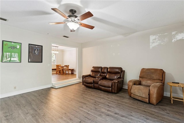 living room featuring hardwood / wood-style floors and ceiling fan