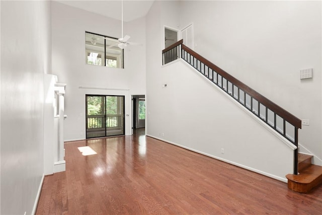 893 Wimbledon Dr, Saint Simons Island, GA 31522 - foyer entrance featuring a high ceiling, wood finished floors, baseboards, stairway, and ceiling fan