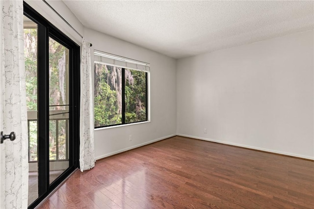 893 Wimbledon Dr, Saint Simons Island, GA 31522 - empty room featuring wood finished floors, a textured ceiling, and baseboards