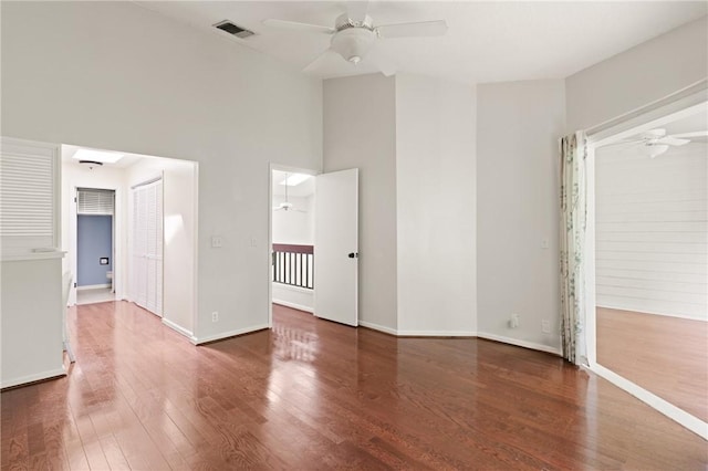 893 Wimbledon Dr, Saint Simons Island, GA 31522 - unfurnished room with ceiling fan, wood finished floors, a high ceiling, and baseboards