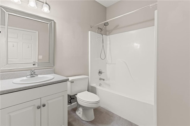 bathroom featuring toilet, tile patterned floors, bathtub / shower combination, and vanity