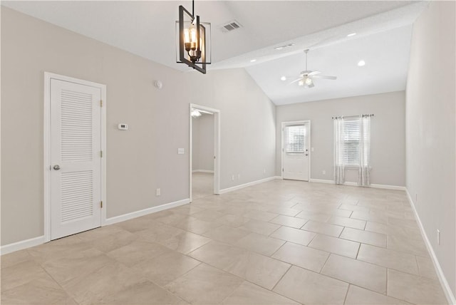 unfurnished room with lofted ceiling, ceiling fan, visible vents, and baseboards