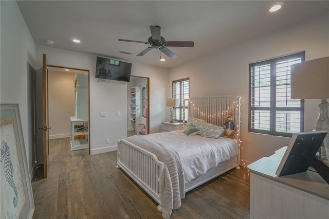 bedroom featuring multiple windows, dark wood-type flooring, and ceiling fan