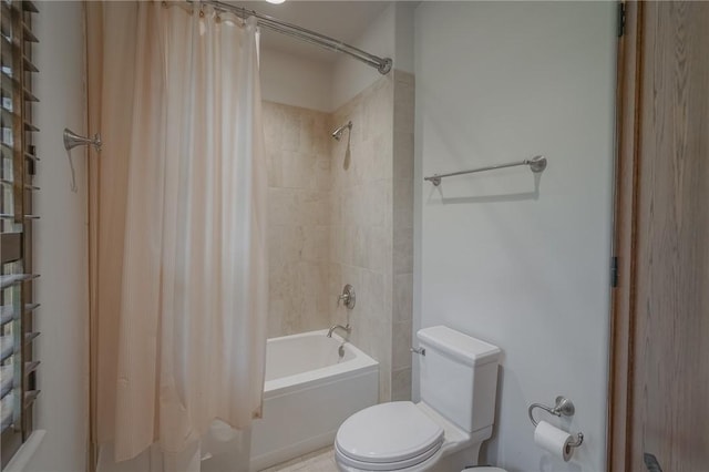 bathroom with shower / tub combo with curtain and toilet