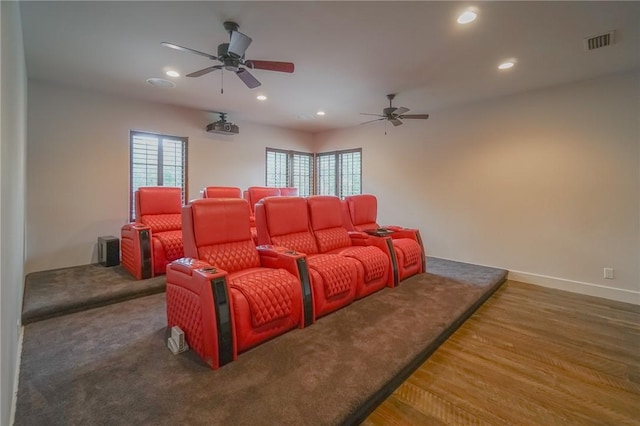 cinema room with dark hardwood / wood-style flooring and ceiling fan