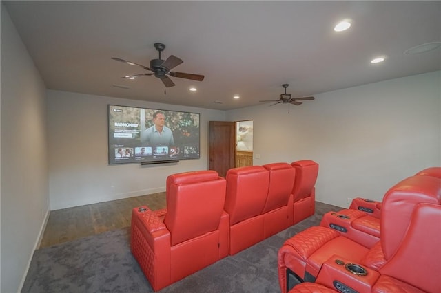 home theater room featuring ceiling fan and dark hardwood / wood-style flooring