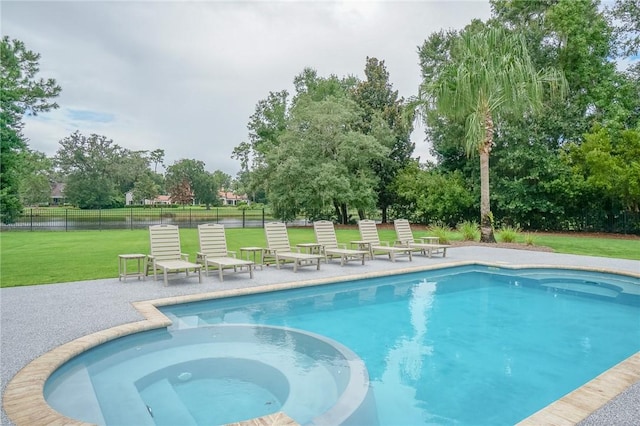 view of pool with a lawn, an in ground hot tub, and a patio