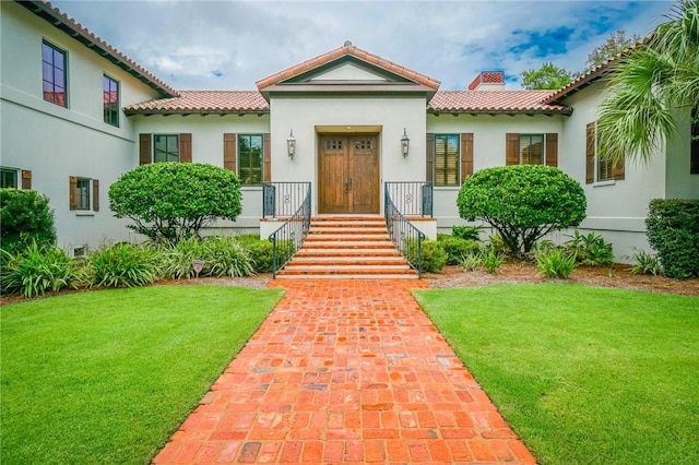 mediterranean / spanish home featuring a front yard