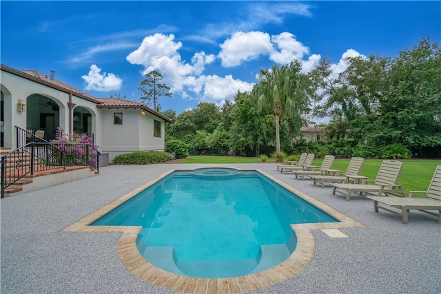 view of swimming pool with a lawn and a patio area