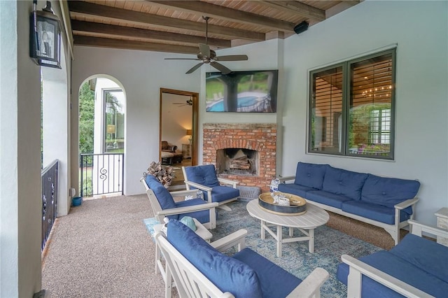 view of patio / terrace with an outdoor living space with a fireplace and ceiling fan