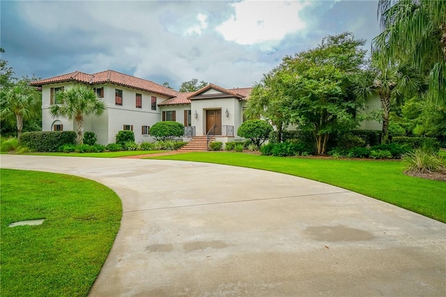 mediterranean / spanish-style home with a front lawn