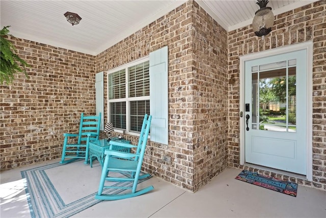 100 Southern Oaks Ln, Saint Simons Island, GA 31522 - doorway to property with brick siding and covered porch