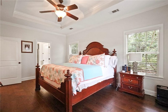 100 Southern Oaks Ln, Saint Simons Island, GA 31522 - bedroom featuring a tray ceiling, wood-type flooring, multiple windows, ornamental molding, and a ceiling fan