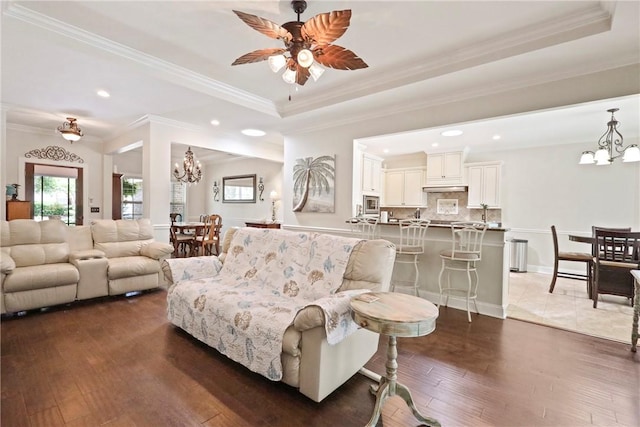 100 Southern Oaks Ln, Saint Simons Island, GA 31522 - living room featuring a chandelier, recessed lighting, dark wood finished floors, a raised ceiling, and ornamental molding